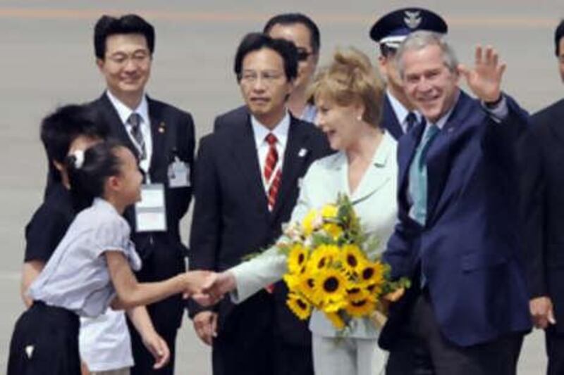 The US president George Bush and his wife Laura are welcomed on their arrival at Chitose International Airport in Hokkaido. The Japanese G8 summit will be Mr Bush's last.