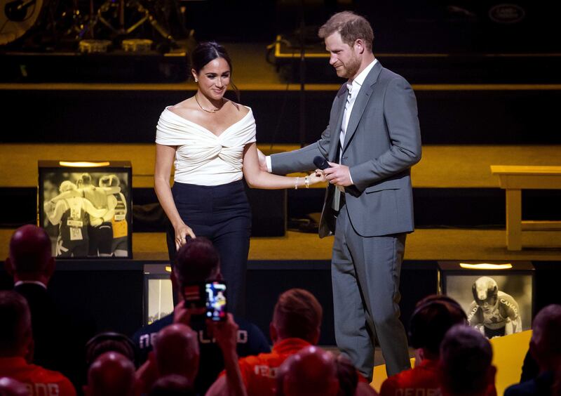 Meghan wears a bardot-style white bodysuit by designer Khaite for the Invictus Games opening ceremony. EPA