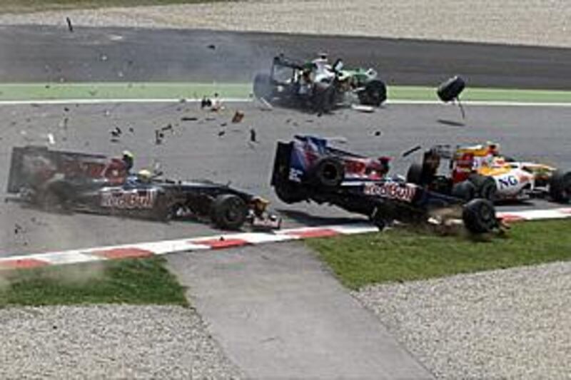 Toro Rosso's Sebatian Buemi, teammate Sebastien Bourdais, Force India's Adrian Sutil and Renault's Nelson Piquet crash at the Circuit de Catalunya at the start of the Spanish Grand Prix