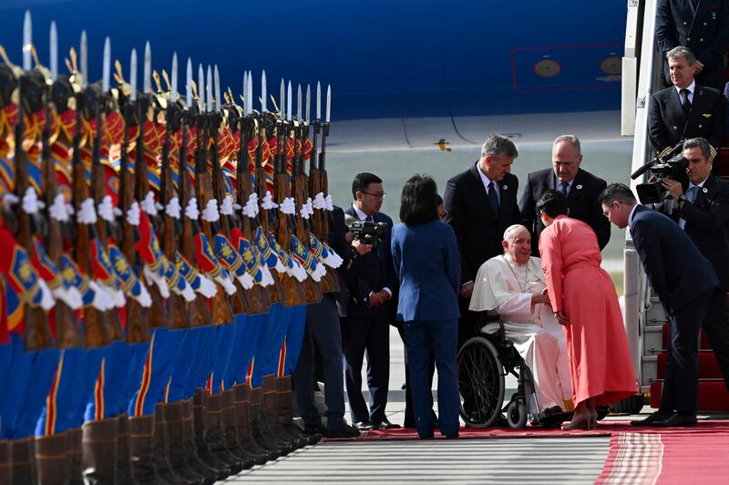The Pope was greeted by Mongolian honour guards wearing traditional blue, red and yellow attire. AFP