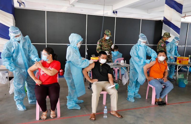 People receive a dose of the China-made Sinovac Covid-19 vaccine during a vaccination drive at a centre in Phnom Penh, Cambodia. EPA