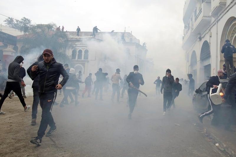 People clash with anti-riot police during the protest against President Abdelaziz Bouteflika, in Algiers, Algeria. Reuters