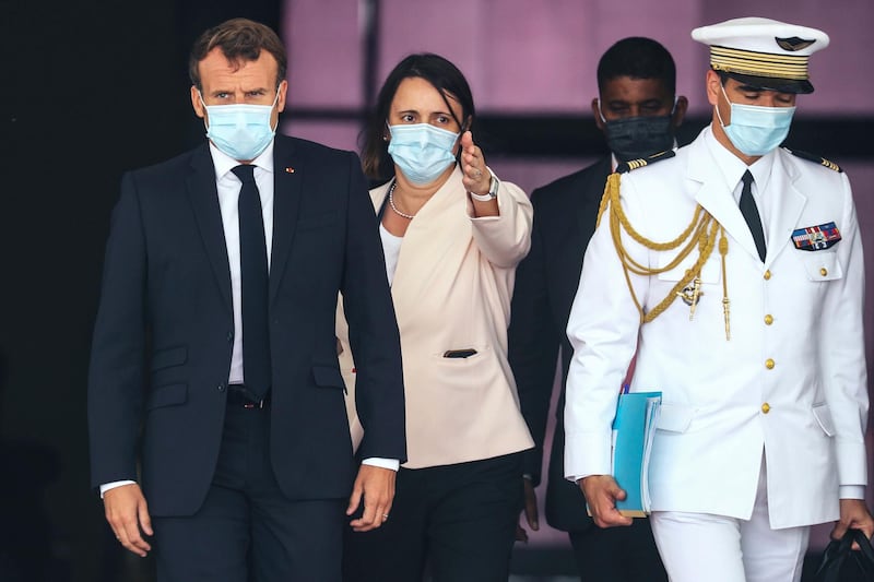 French President Emmanuel Macron, left, wears a face mask as he arrives at Nouakchott Oumtounsy International Airport Tuesday June 30, 2020, in Nouakchott, to attend a G5 Sahel summit. Leaders from the five countries of West Africa's Sahel region, Burkina Faso, Chad, Mali, Mauritania and Niger, meet with French President Emmanuel Macron and Spanish Prime Minister Pedro Sanchez in Mauritania's capital Nouakchott on Tuesday to discuss military operations against Islamic extremists in the region, as jihadist attacks mount. The five African countries, known as the G5, have formed a joint military force that is working with France, which has thousands of troops to battle the extremists in the Sahel, the region south of the Sahara Desert. (Ludovic Marin, Pool via AP)