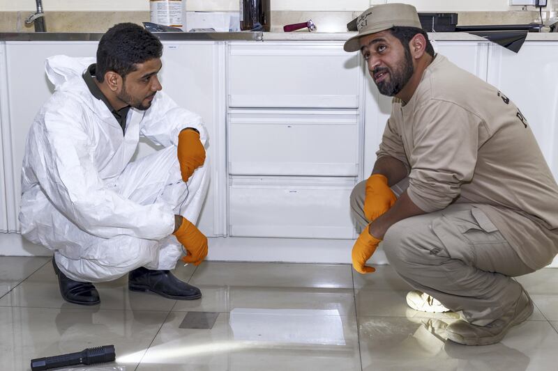Ajman, UAE - September 05, 2017 - Mohd Hussain Waheedi and Ali Saif Al Shamsi of the Ajman Police Crime Scenes Investigative Unit demonstrate how they collect dust prints from crime scenes - Navin Khianey for The National