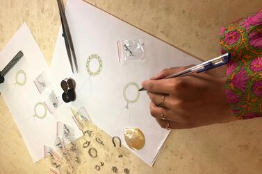 Sheikha Mariam, seen here sketching earrings for her upcoming collection, loves stacking jewellery, especially rings and bracelets, in her everyday look and while on holiday. Photo: Sarvy Geranpayeh