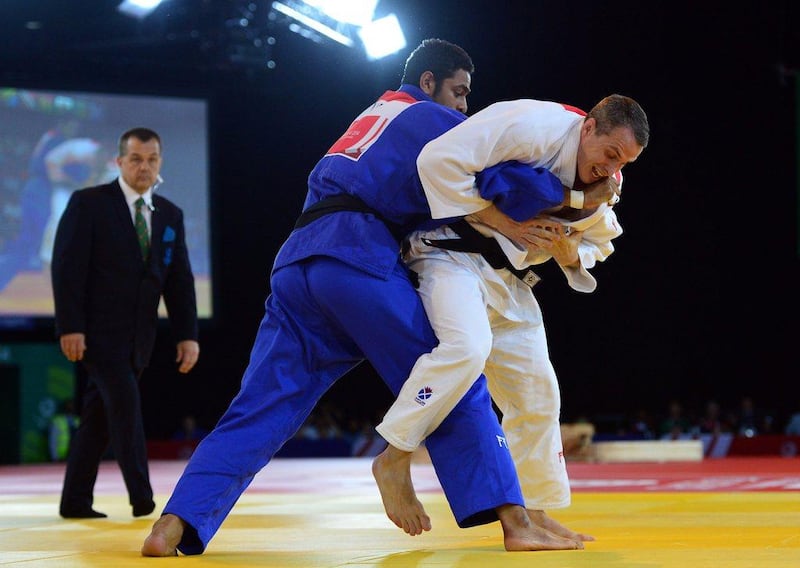 Pakistan's Shah Hussain, left, won silver at the 2014 Commonwealth Games in judo. Carl Court / AFP