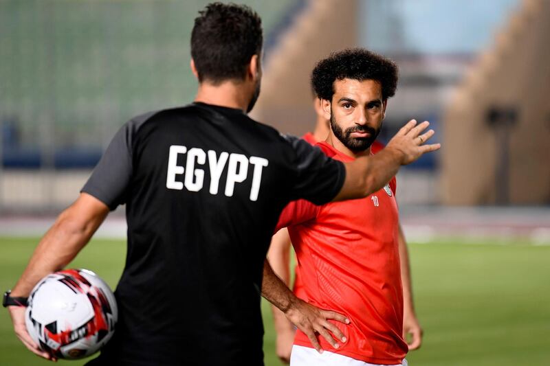 Salah listens to a coach during a training session. AFP