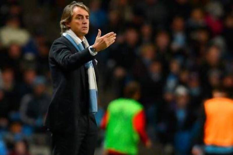 Manchester City manager Roberto Mancini says his side would have defended their Premier League title if only he had managed to sign a number of his transfer targets. Andrew Yates / AFP