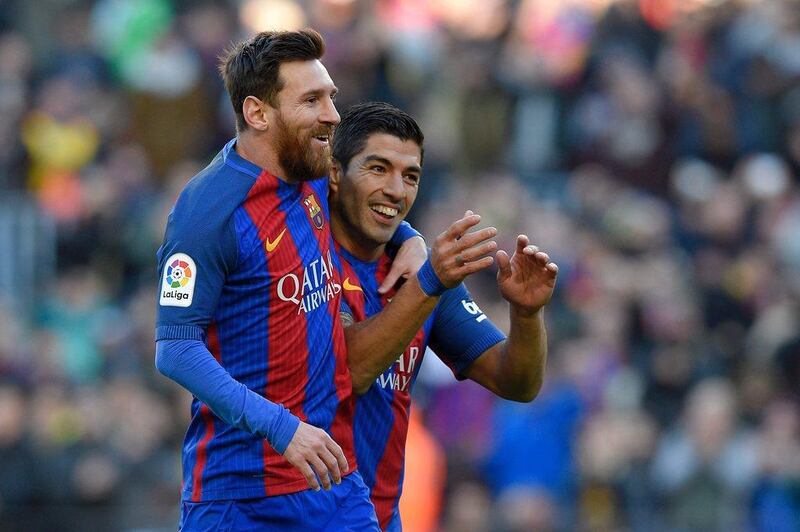 Barcelona’s Lionel Messi and Luis Suarez celebrate against Las Palmas. Luis Gene / AFP