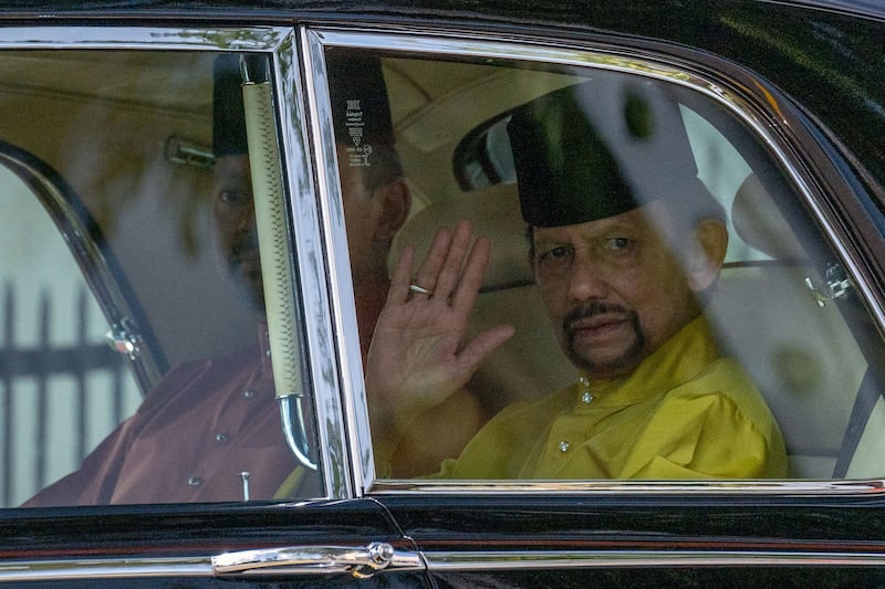 Sultan Hassanal Bolkiah waves as he arrives for his son's  solemnisation ceremony. AFP