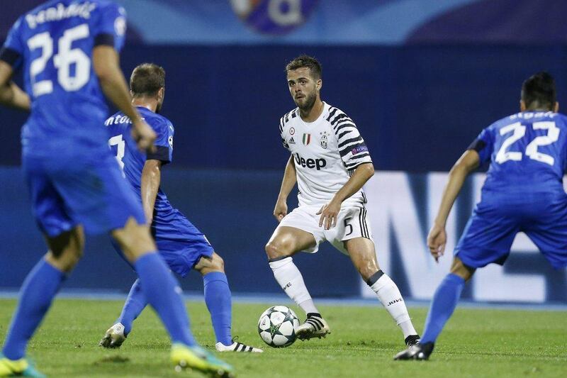 Juventus’ Miralem Pjanic, centre, controls the ball against Dinamo Zagreb’s Domagoj Antolic, background left. Darko Bandic / AP Photo