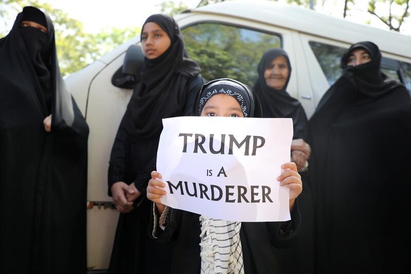 A girl holds a sign reading “Trump is a murderer” during a condolence ceremony for Qassem Suleimani outside the Embassy of Iran in Kuala Lumpur, Malaysia. Reuters