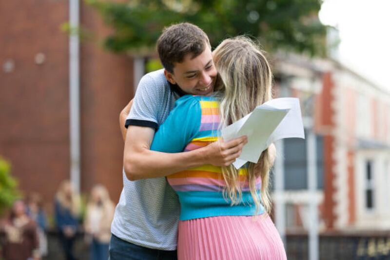 Noah Dunstan hugs his mother after opening his GCSE results at Ffynone House School in Swansea, Wales.