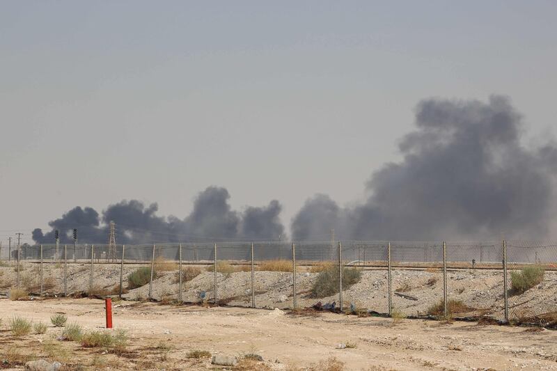 TOPSHOT - Smoke billows from an Aramco oil facility in Abqaiq about 60km (37 miles) southwest of Dhahran in Saudi Arabia's eastern province on September 14, 2019. Drone attacks sparked fires at two Saudi Aramco oil facilities early today, the interior ministry said, in the latest assault on the state-owned energy giant as it prepares for a much-anticipated stock listing. Yemen's Iran-aligned Huthi rebels claimed the drone attacks, according to the group's Al-Masirah television.
 / AFP / -
