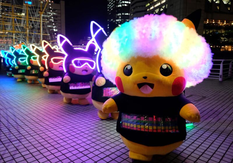 Performers dressed as Pikachu, the popular animation Pokemon series character, participate in a light performance during the Pikachu parade in Yokohama.  AFP