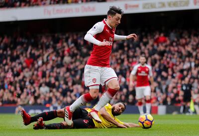 Soccer Football - Premier League - Arsenal vs Watford - Emirates Stadium, London, Britain - March 11, 2018   Arsenal's Mesut Ozil in action with Watford's Adrian Mariappa    REUTERS/Eddie Keogh    EDITORIAL USE ONLY. No use with unauthorized audio, video, data, fixture lists, club/league logos or "live" services. Online in-match use limited to 75 images, no video emulation. No use in betting, games or single club/league/player publications.  Please contact your account representative for further details.