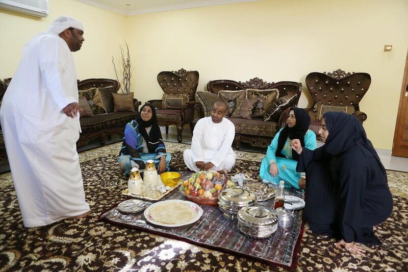 Umm Saif, second left, with, from left, her sons Ali Saeed and Saif, and her daughters Najla Saeed and Mouza, at the majlis area of the family home in Hatta in Dubai. Pawan Singh / The National