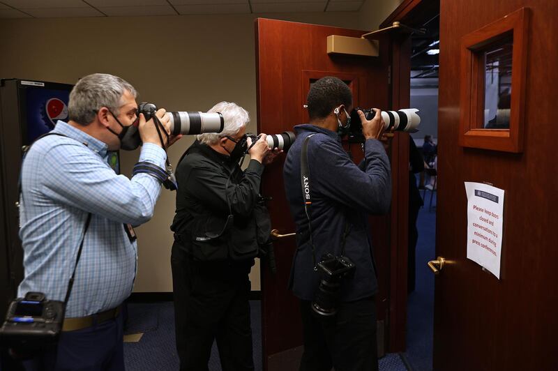 Photographers shoot through a doorway a Democratic news conference on statehood for the District of Columbia at the US Capitol, in Washington, on April 21, 2021. AFP