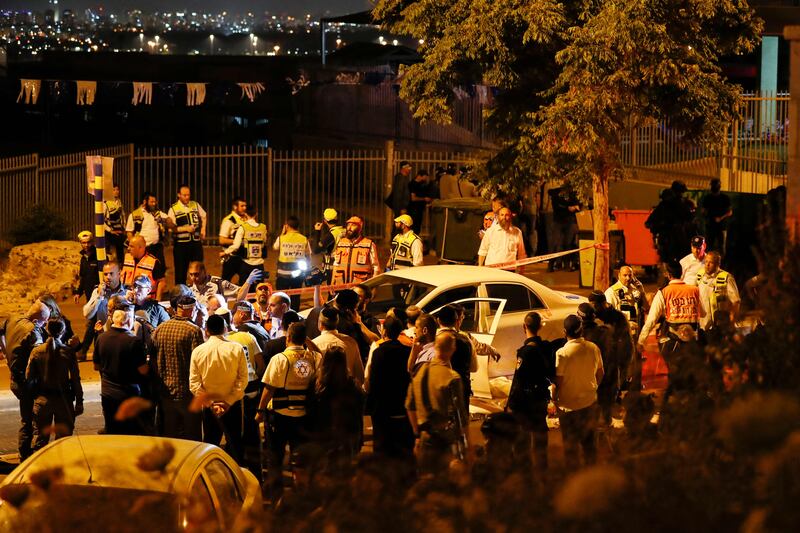 Israeli police and medics are pictured at the scene the attack in the central city of Elad. AFP