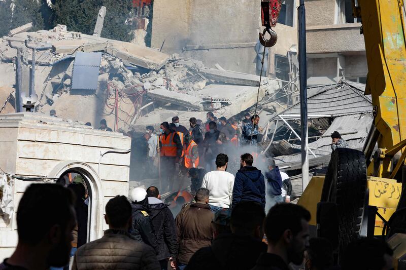 Emergency workers search for survivors under the rubble of the collapsed building. AFP