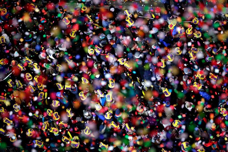 Confetti drops over the crowd as the clock strikes midnight in New York's Times Square. Seth Wenig / AP Photo