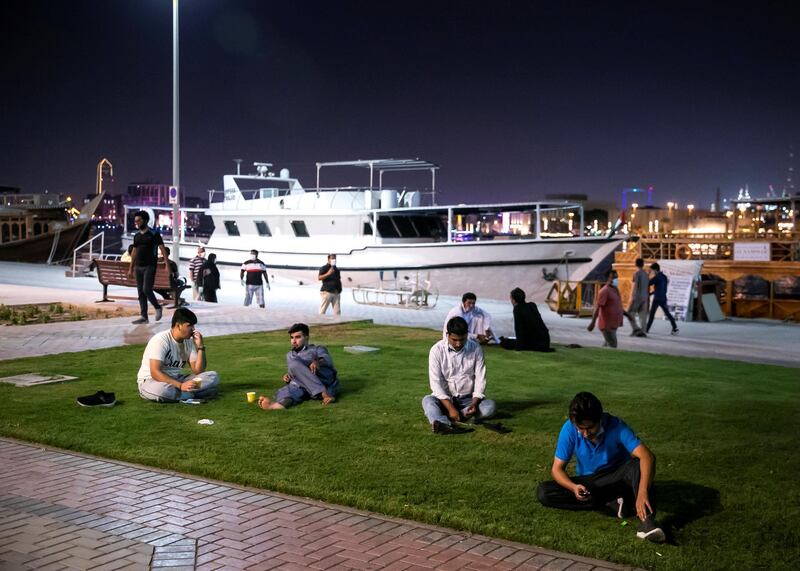 DUBAI, UNITED ARAB EMIRATES. 2 JUNE 2020. 
Men sitting on the grass by Dubai Creek in Baniyas, Deira.
(Photo: Reem Mohammed/The National)

Reporter:
Section: