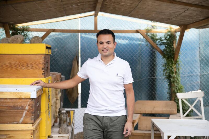 DUBAI, UNITED ARAB EMIRATES - JUNE 7, 2018. 

Jameel Khan at the beehive farm in Dubai Sustainable City.
A new programme ‘My Hive,’ was launched by The Sustainable City (TSC) in partnership with the Apiculture and Nature for the Betterment of Health and Beauty (ANHB). The programme grants individuals and corporations the opportunity to adopt a beehive of their own.

The programme was launched by Shaikh Salem Sultan Al Qasimi, Chairman of ANHB, after the TSC purchased 250 new beehives to provide residents with organic honey and raise awareness of the important ecological role of bees.

(Photo by Reem Mohammed/The National)

Reporter: Ramola Talwar
Section: NA