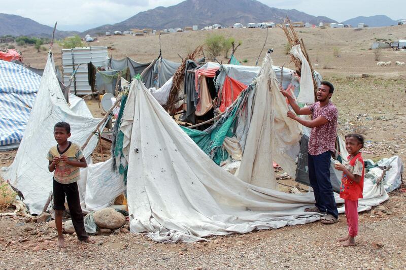 A Yemeni man rebuilds his tent after it was destroyed by torrential rain in a makeshift camp for the displaced in the northern Hajjah province, on April 19, 2020. / AFP / ESSA AHMED
