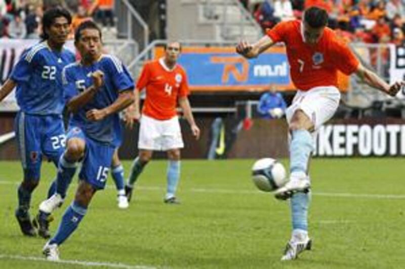 Holland and Arsenal forward Robin van Persie, right, scores during his side's 3-0 friendly victory over Japan in Enschede on Saturday as Yuto Nagamoto (15) and Yuji Nakazawa (22) look on.