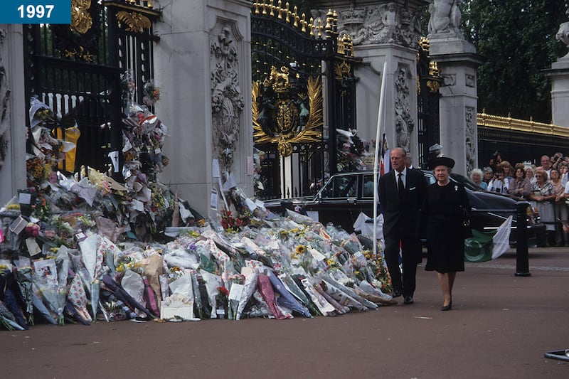 1997: The queen and Prince Philip view tributes from the public outside Buckingham Palace to Diana, Princess of Wales, after her funeral.