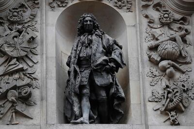 A statue of English merchant and slave trader John Cass is mounted on the wall of the Sir John Cass Foundation in central London. The authority that runs London's financial district announced recently it will retain two statues of colonial-era figures linked to slavery that it had previously planned to remove. AFP