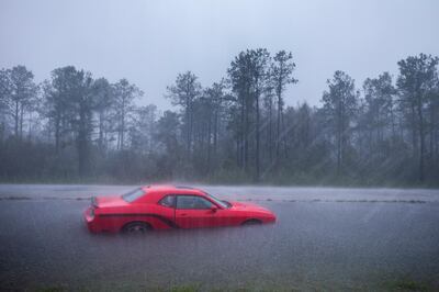 epaselect epa07023443 An abandoned car that was flooded by Hurricane Florence along Route 17 near Holly Ridge, North Carolina USA, 15 September 2018. Storm surge and heavy flooding from the hurricane has inundated much of Eastern North Carolina. Florence has been downgraded to a tropical storm but is still expected to bring a storm surge with heavy flooding to the Carolinas.  EPA/JIM LO SCALZO