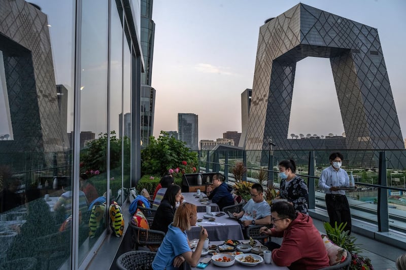 BEIJING, CHINA - MAY 12: People dine at a restaurant overlooking the Central Business District on May 12, 2021 in Beijing, China. China's economy has shown signs of bouncing back as the pandemic is largely under control. (Photo by Kevin Frayer/Getty Images)