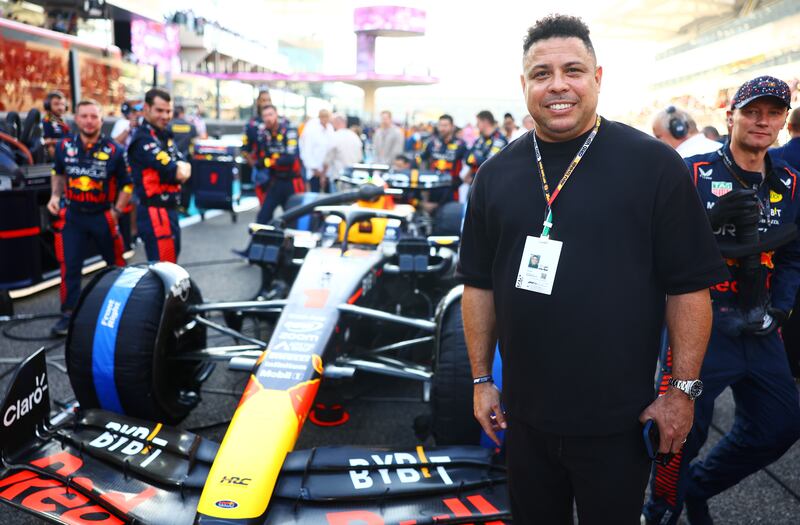 Former footballer Ronaldo poses for a photo with the car of Max Verstappen of the Netherlands and Oracle Red Bull Racing on the grid before the Grand Prix. Getty Images