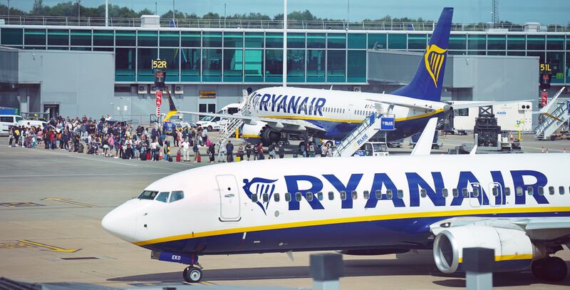 Passengers queue to board Ryanair aircraft at Stansted Airport, in south-east England. The airline is adding 500 flights from Stansted. PA