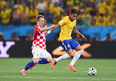 SAO PAULO, BRAZIL - JUNE 12:  Luka Modric of Croatia tackles Neymar of Brazil  during the 2014 FIFA World Cup Brazil Group A match between Brazil and Croatia at Arena de Sao Paulo on June 12, 2014 in Sao Paulo, Brazil.  (Photo by Buda Mendes/Getty Images)