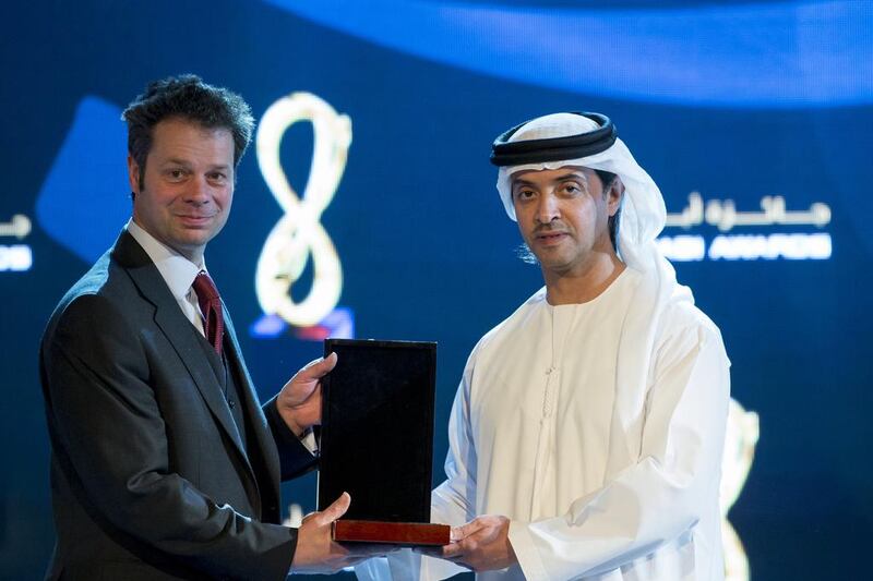Sheikh Hazza bin Zayed, right, presents an award to Mark Upton, who received it on behalf of his father Roger Upton. Mr Upton the elder was honoured for his role in helping preserve an essential Bedouin custom. Ryan Carter / Crown Prince Court — Abu Dhabi