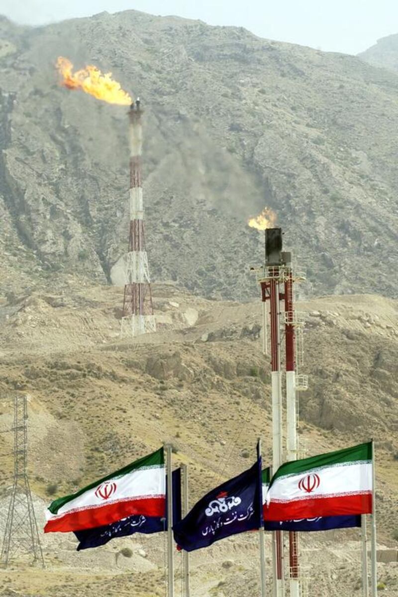 3rd: National Iranian Oil Co. - 6 million boepd. Pictured, Iranian national flags and flags of Iran's national oil company fly under torches that burn excess-gas at a part of the facility of the phases 4 and 5 of South Pars gas field. AP Photo