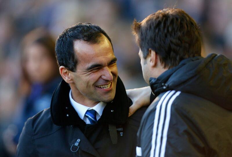 Everton Manager Roberto Martinez, left, is greeted by Southampton Manager Mauricio Pochettino prior to their Premier League match at Goodison Park on Sunday. Paul Thomas / Getty Images