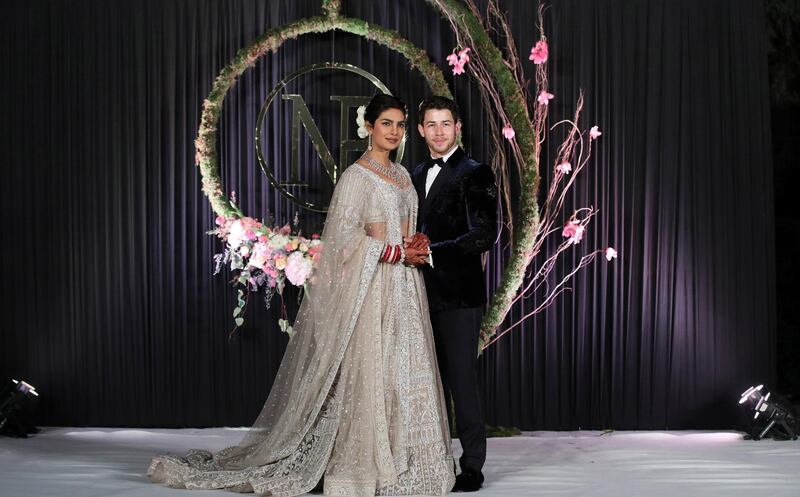 Newlyweds Priyanka Chopra, 36, and Nick Jonas, 26, pose for a photograph during a reception at a hotel in New Delhi on December 4, 2018. Photo: EPA