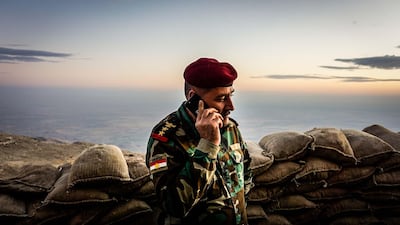 Staff Colonel Srud Barzanji, who heads the Peshmerga’s 46th Division, on the phone at an outpost in the Qara Chokh mountains. Jack Moore / The National