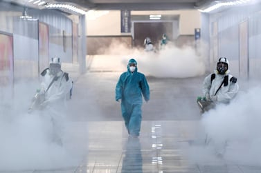 Volunteers in protective suits disinfect a railway station as the country is hit by an outbreak of the new coronavirus, in Changsha, Hunan province, China February 4, 2020. cnsphoto via REUTERS ATTENTION EDITORS - THIS IMAGE WAS PROVIDED BY A THIRD PARTY. CHINA OUT. TPX IMAGES OF THE DAY