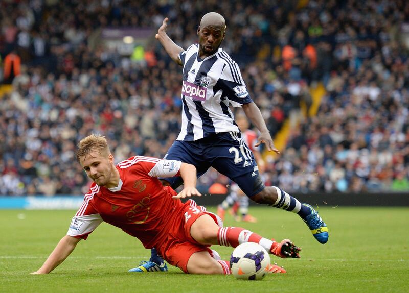 WEST BROMWICH, ENGLAND - AUGUST 17:  Luke Shaw of Southampton falls under pressure from Youssuf Mulumbu of West Bromwich Albion  during the Barclays Premier League match between West Bromwich Albion and Southampton at The Hawthorns on August 17, 2013 in West Bromwich, England.  (Photo by Michael Regan/Getty Images) *** Local Caption ***  176687953.jpg