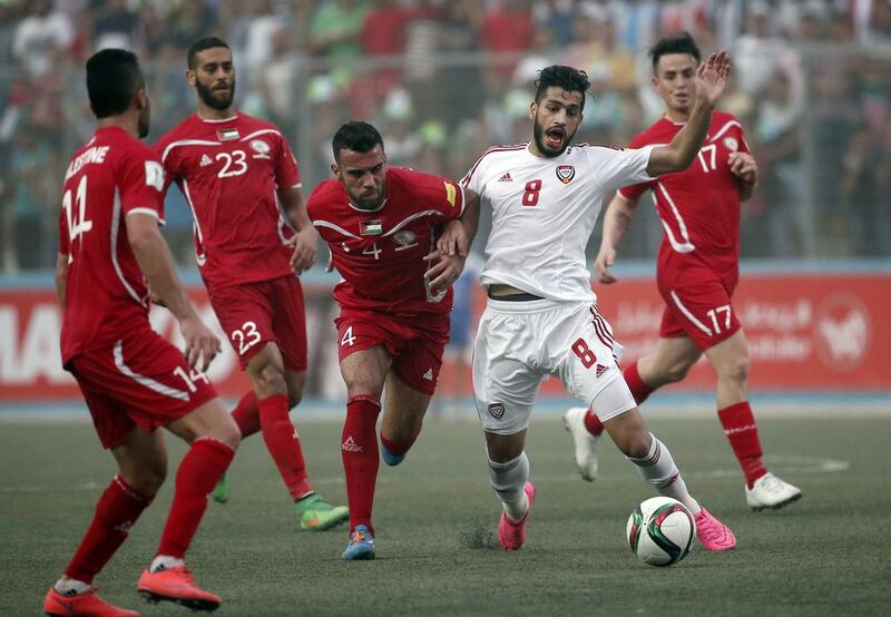 Palestinian player Haytham Theeb, centre, vies for the ball with the UAE’s Majed Hassan, second right, during their 2018 World Cup qualifier at the Faisal al-Husseini Stadium, on September 8, 2015 in the West Bank town of Al-Ram. Thomas Coex / AFP