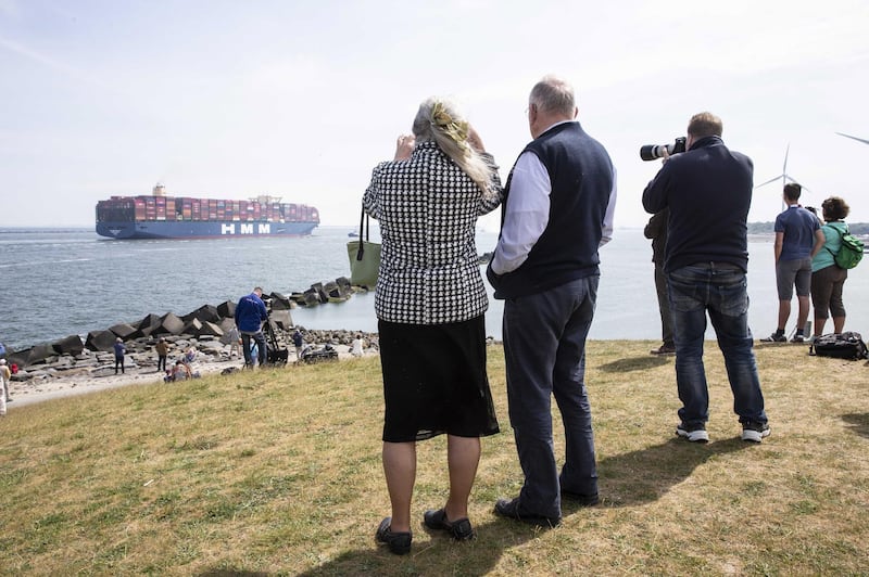People watch and take photographs as the largest container ship in the world, the HMM Algeciras, arrives in Rotterdam, the Netherlands. EPA