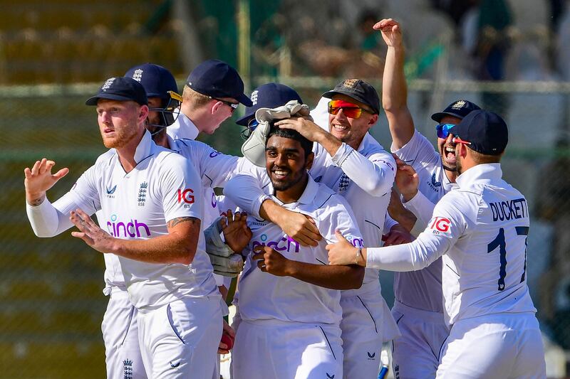 England's Rehan Ahmed celebrates with teammates after taking the wicket of Pakistan's Saud Shakeel during the first day of the third Test at the National Stadium in Karachi on December 17, 2022. AFP