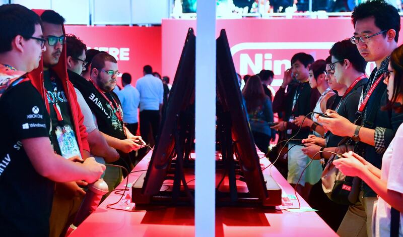 (FILES) In this file photo taken on June 13, 2018 Gaming fans play Super Smash Bros on Nintendo Switch at the 24th Electronic Expo, or E3 2018, in Los Angeles, California where hardware manufacturers, software developers and the video game industry present their new games.  / AFP / Frederic J. BROWN

