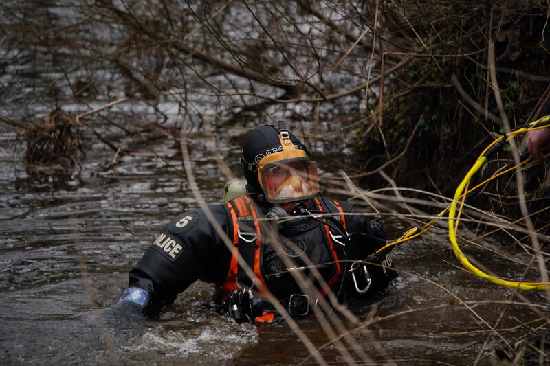 A diver takes part in a search of the river. PA