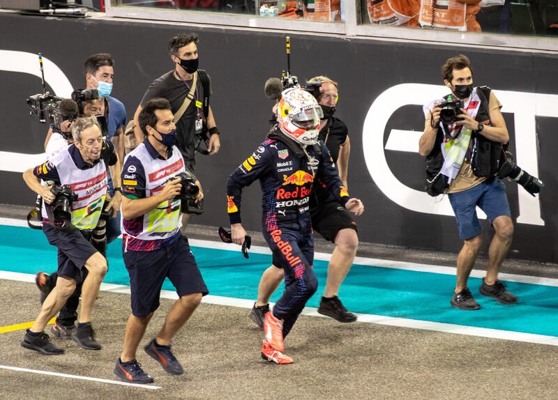 Verstappen runs to celebrate with his team. Victor Besa / The National