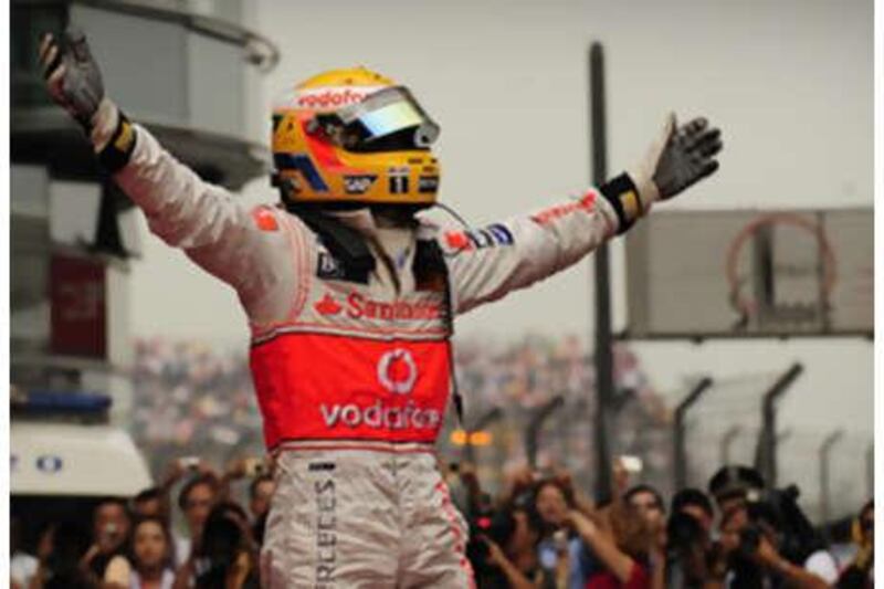 Lewis Hamilton celebrates in front of the world's media after winning yesterday's Chinese Grand Prix.